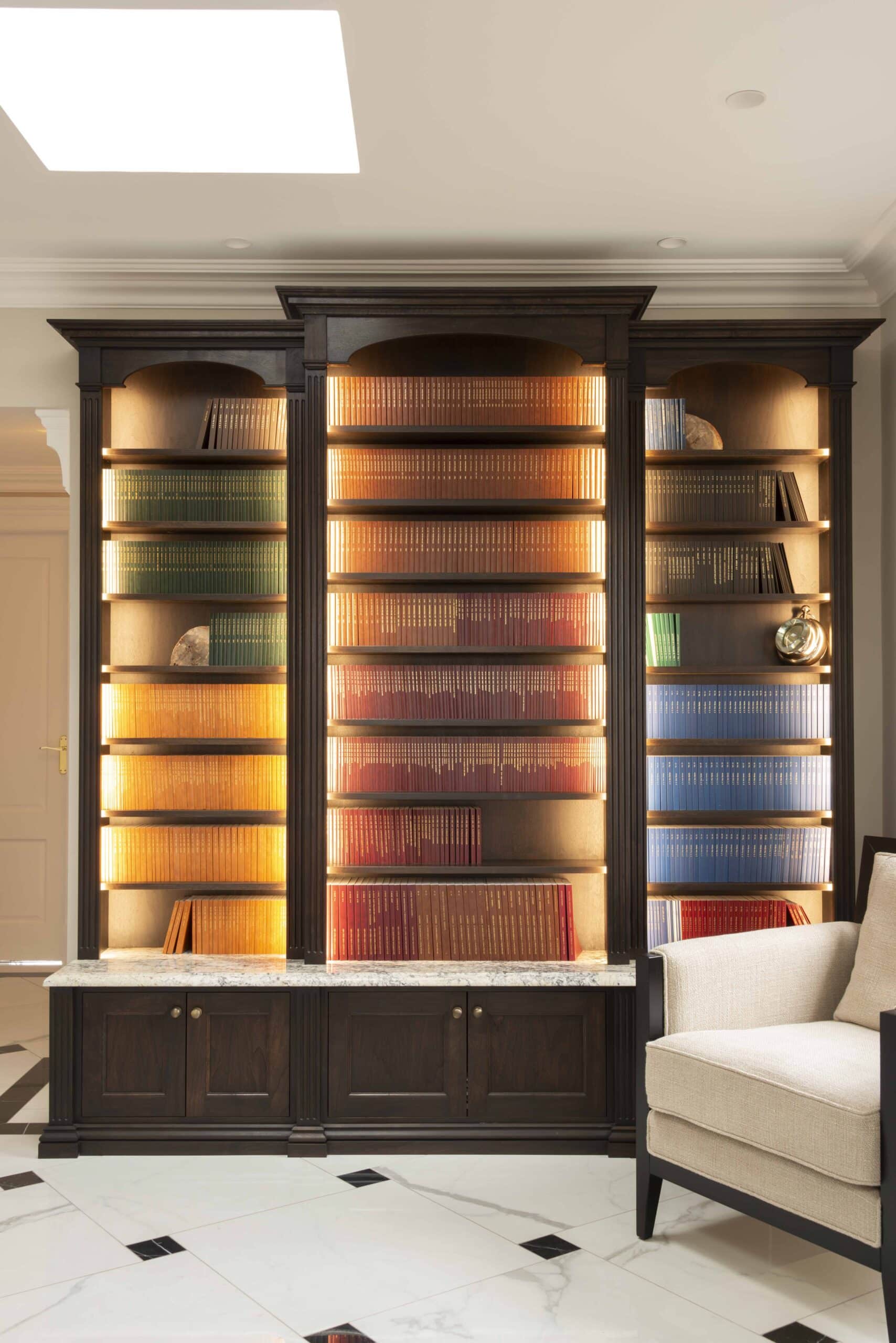 Bookcase in period design with backlights forms part of a collection of bespoke furniture for a Victorian House
